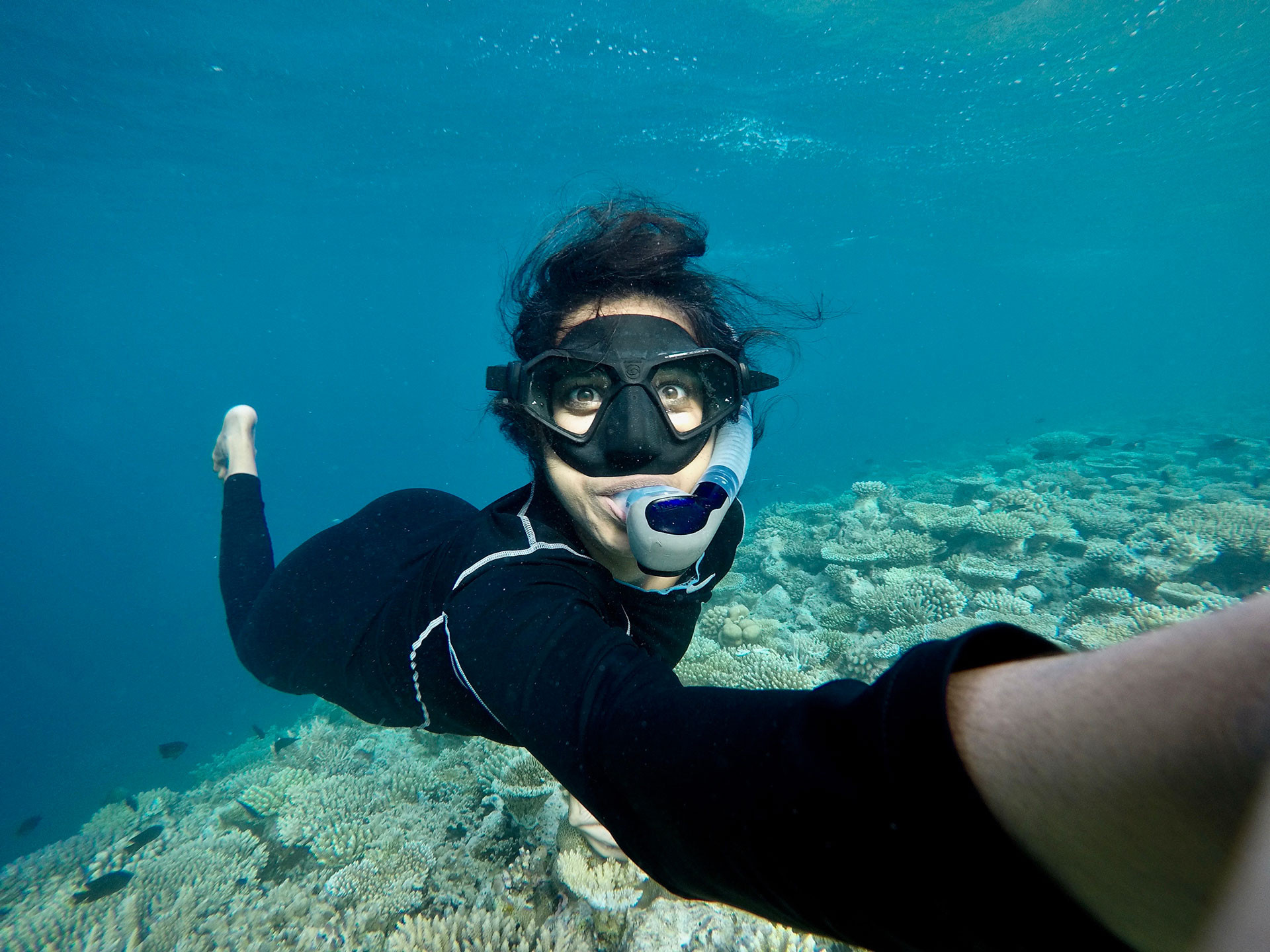 Shreya Yadav marine biologist diving underwater near a coral reef